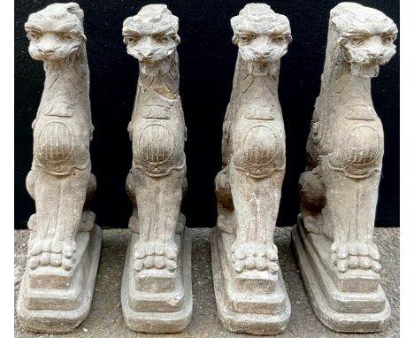 A set of four composition architectural caryatids, each modelled as a griffin, 49cm high**Please note that some of the lots i