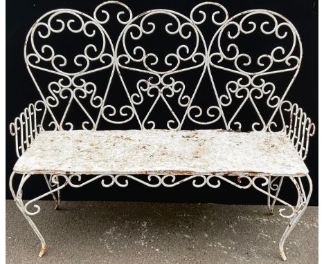 An early 20th century three seat wire work garden bench, scroll back and legs, solid seat, 113cm wide**Please note that some 