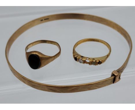 A 9ct gold bangle, 9ct gold signet ring and 18ct gold ring [missing stones] [9ct- 8.92grams] [18ct- 2.16grams] 