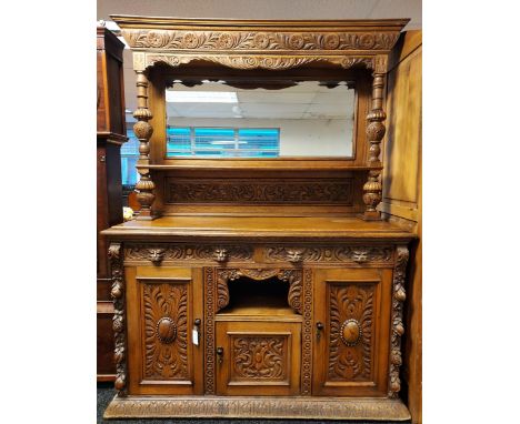 19th century oak dresser, heavily carved throughout with a green man, leaf and flower decoration, cornice above an open shelf