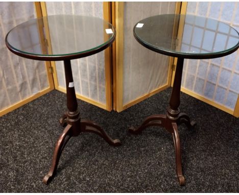 Matching pair of mahogany lamp tables, circular top with glass insert, supported on a tripod base [62x38cm] 