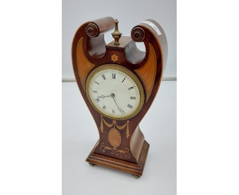 An Edwardian inlaid mantle clock. In a working condition. 
