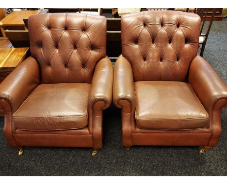 Brown leather upholstered arm chairs, straight button back, supported on front turned supports ending in castors and back blo