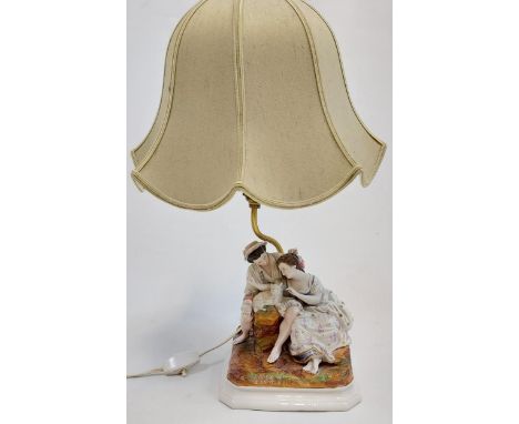 An early 20th century porcelain group figurine table lamp. 