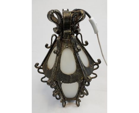 A Heavy wrought iron and frosted glass porch lantern. Working. [42cm in height] 
