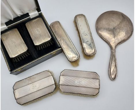 A Selection of silver hall marked dressing table brushes and hand mirror 