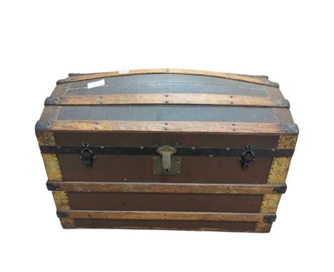 A Victorian domed top travelling trunk with wood and brass mounts, by Benson, Great Russel Street (labelled inside) and with 