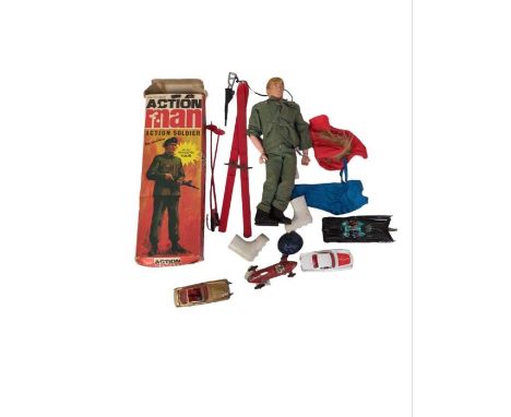 A Palitoy Action Man wearing fatigues and beret with machine gun, in original box and also with skiing equipment and clothing