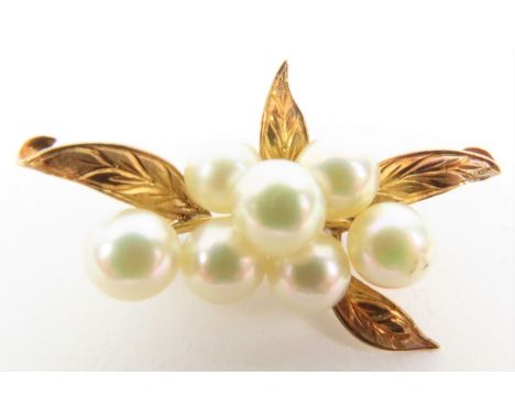 A seven stone set cultured pearl brooch, stamped ‘K14’, 3.8 cm long, 6 grams gross 