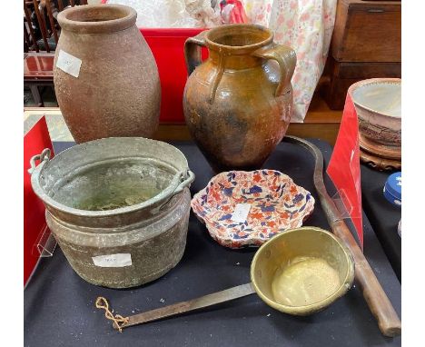 A large glazed earthenware two handled jar 35cm high, another tall earthenware jar, brass ladle and pot, hand tool and decora