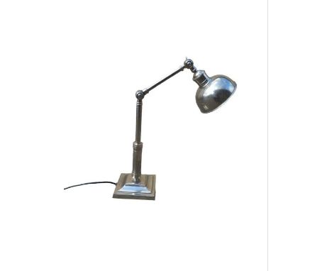 A polished white metal adjustable desk lamp on stepped square base  