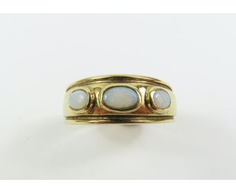 A 9 Carat gold three stone opal ring, finger size P, 3.4 grams gross