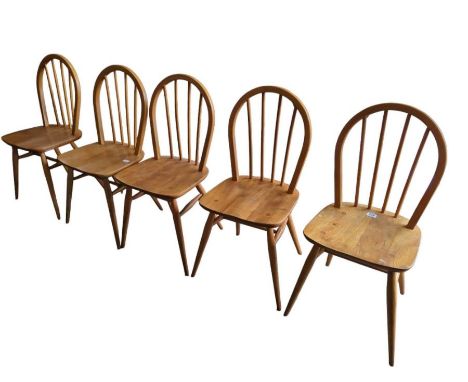 A set of five Ercol light wood stick back chairs