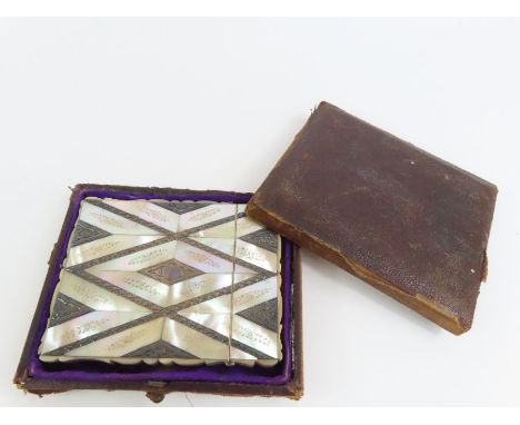 A Victorian mother of pearl and silver metal card case having shaped sides and in original box 