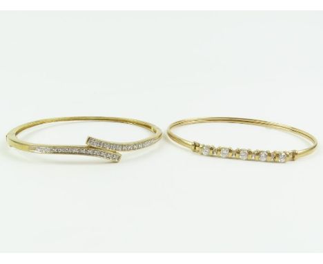 A 9 carat gold bangle with a stone set frontispiece; with a hinged bangle with a diamond set cross over frontispiece; 12.2 gr