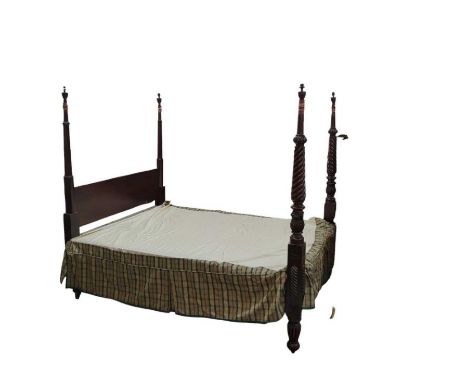 A 19th century mahogany four poster bed having later padded tapestry headboard flanked by spiral twist and foliate supports a