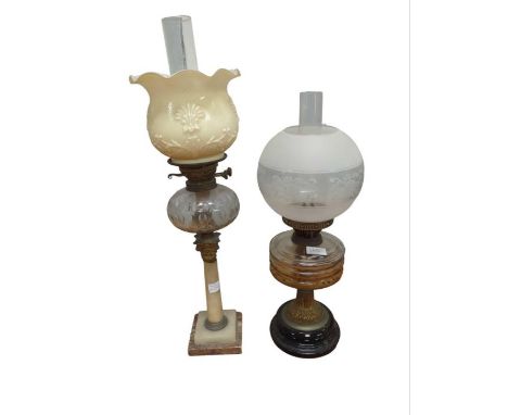 A Victorian oil lamp with faceted clear glass reservoir, moulded glass shade, gilt metal and onyx Corinthian column and stepp