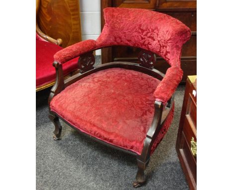 A Victorian mahogany tub chair, scrolling padded back, padded arms and seat, French cabriole forelegs, ceramic casters. 