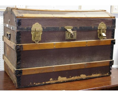 A dome top wood and metal bound trunk. 54cm high x 78cm wide x 46cm deep. 