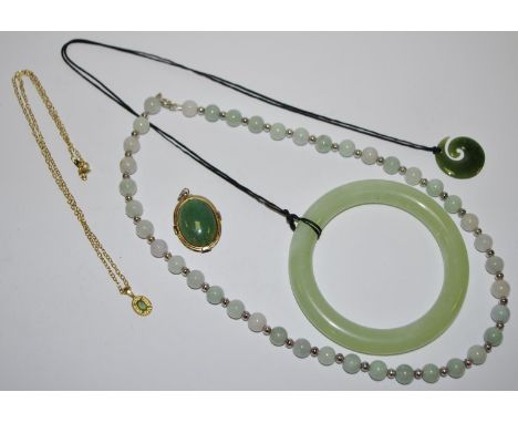 A jade bangle; a jade bead necklace; two jade pendants , one mounted etc. 