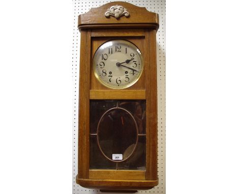 A 1940's oak wall clock. 