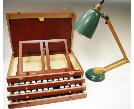 An artists easel paint box, hinged lid revealing easel, three drawers coating oil paints and brushes; a wood angle desk lamp 