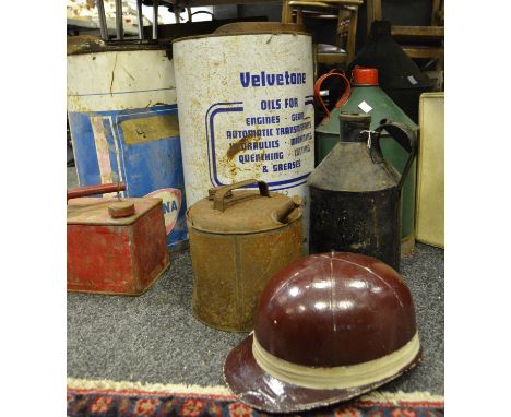 An Everoak racing helmet; vintage petroleum spirit cans; Esso tractor lube drum; Fina, Castrol, Velvetone tractor oil cans et