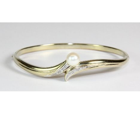 A 9ct gold diamond and cultured pearl bangle
