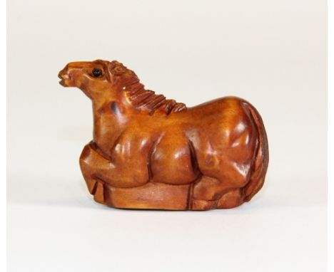 A signed fruitwood netsuke of a horse with black onyx eyes