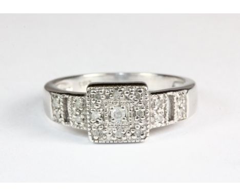 A white metal (tested min 9ct gold) pave set diamond ring (K)