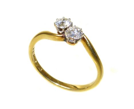 A diamond two-stone 18ct gold cross-over ring two round brilliant cut diamond, a total diamond weight of approx 0.33ct Condit