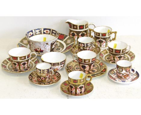 A collection of Royal Crown Derby teaware to include two bowls, a cake plate, a trio of cups and saucers, jug and loving cup 