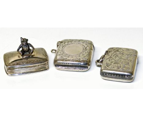 Two silver vesta cases together with a silver pill box surmounted with bear (3) Condition reports are not available for our I