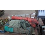 Pallet of large machine/ transport canvas/ tarps. 4 in total. Plus a double combination ladder.
