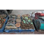 The contents of a pallet of assorted rachet straps/ lifting chains.