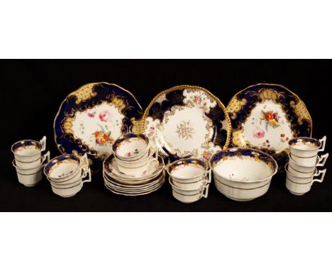 An English porcelain flower-painted part tea and coffee service, with blue and gilt borders, comprising a slop bowl, six teac