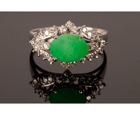 A jade and diamond dress ring set in 18k white gold, the oval jade measuring 9.5mm x 7mm, size R, approximately 4g CONDITION 