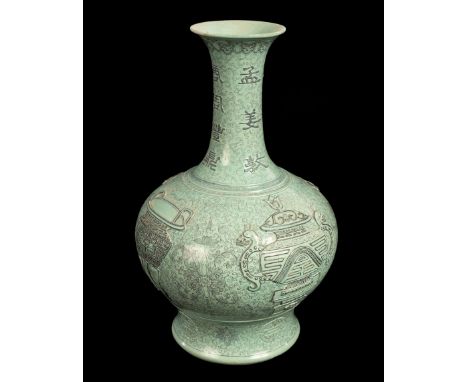 A Chinese turquoise ground porcelain vase, decorated in relief with character marks to the neck and archaic vessels to the si