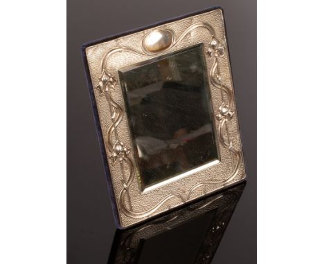 An Art Nouveau silver photograph frame, A & J Zimmerman, Birmingham 1902, the bevelled glass with silver surround decorated s