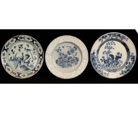 Two English blue and white Delftware chargers and a Dutch example, one with white foliate border, the English chargers 33.5cm