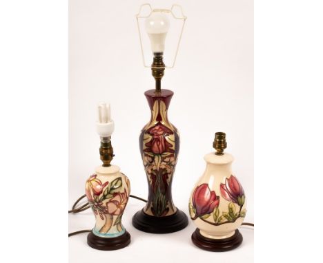 A Moorcroft pottery lamp and shade, painted tulips and two other Moorcroft lamps both with shades CONDITION REPORT: All three
