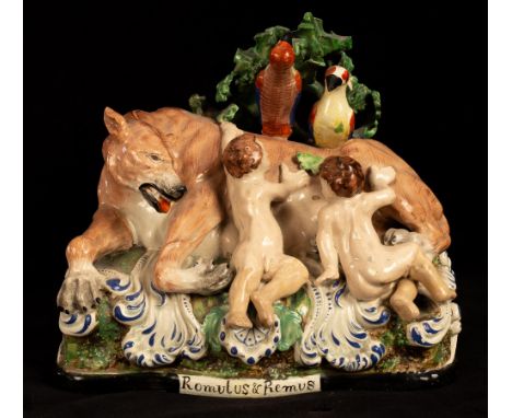A Staffordshire pearlware figure group of Romulus and Remus on a titled mound base with acanthus scrolls, circa 1800, 19cm lo