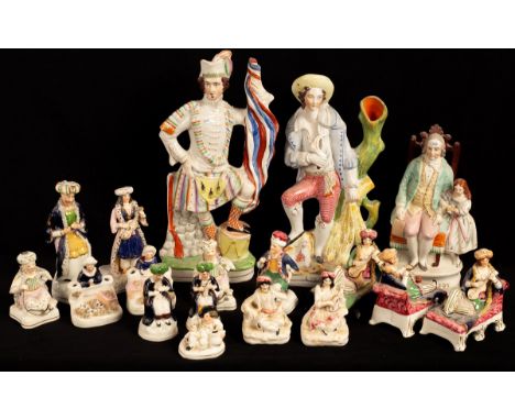A group of Staffordshire porcelain figures of 'Turks' including a pair reclining on a chaise, circa 1850, three small spill v