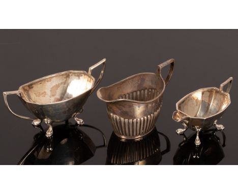 A half-ribbed silver cream jug, Chester 1899, a two-handled sugar basin and matching cream jug, approximately 205g CONDITION 
