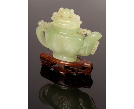 A Chinese carved jade teapot, 15cm high including stand CONDITION REPORT: Condition information is not usually provided in th