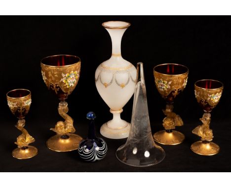 A set of four graduated ruby glass and gilt goblets on dolphin stems, an opaque white glass vase, an epergne trumpet and a bl