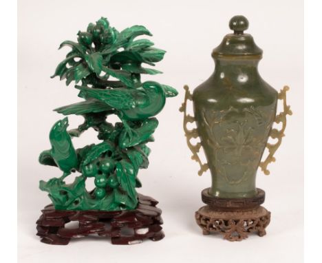 A Chinese carved spinach jade vase with lotus leaf relief to the sides, two pierced handles and a lid, 13cm high, another of 