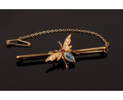 An Edwardian novelty insect brooch with split pearl wings, an aquamarine body and a ruby head, set on a 15ct yellow gold bar,