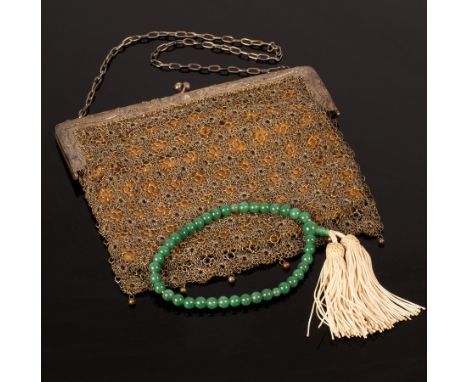 A white metal and chain mail evening bag, the clasp decorated dragons, 17cm wide x 17cm high and a string of jade beads with 