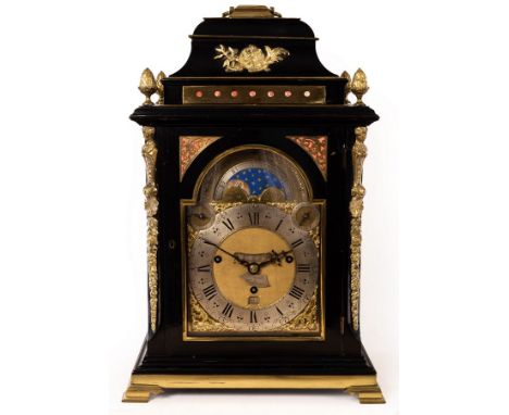 A George III ebony veneered eight-day, quarter-chime table clock by Gravell, London, the case with brass mounts and caryatids